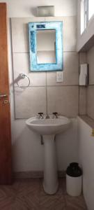 a bathroom with a sink and a mirror on the wall at Cedro Azul in Monte Hermoso +8 photos