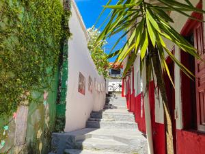 a narrow alley with stairs between two buildings at Colombia Hostel in Porto Seguro