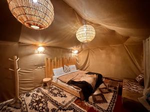 a bedroom with a bed in a tent at Sahara wellness camp in Merzouga