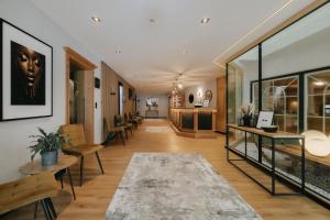 a hallway with tables and chairs in a building at Wohlfühlhotel KERSCHDORFER - B&B - ADULTS ONLY in Kaltenbach