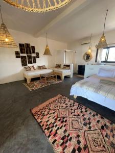 a bedroom with two beds and a rug at Kalao beach in Cap Skirring