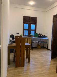 a room with a table and a chair and a desk at Menuks villa in Habaraduwa Central