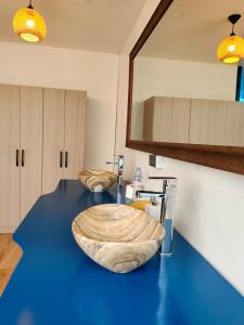 a room with a table with a large wooden bowl on it at Uros Titicaca Kurmi lodge in Puno +36 photos