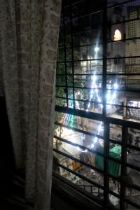 a window with a view of a bird cage at Zest Homes Nugambakkam in Chennai