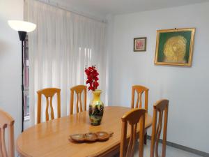 a dining room with a table with a vase on it at Alojamiento San Juan en Murcia Centro in Murcia +36 photos
