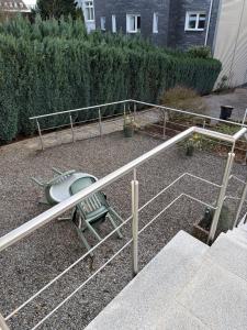 a metal railing in a yard with a bench at Pension Hoffmann Remscheid in Remscheid +3 photos
