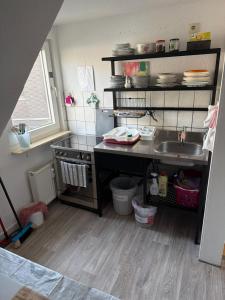 a small kitchen with a sink and a counter at Pension Hoffmann Remscheid in Remscheid