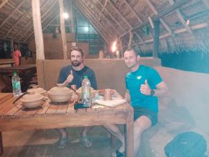 two men sitting at a table giving thumbs up at Nature Win Yala in Hambantota +33 photos