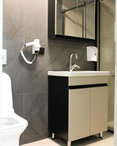 a bathroom with a sink and a mirror and a toilet at Viva Nova Suit Hotel in Bakanlıklar +22 photos