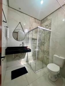 a bathroom with a shower and a toilet and a sink at Studio - Serraruna in Araruna +9 photos