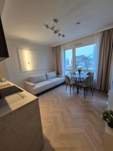 a living room with a couch and a table at STARCO Apartamenty obok dworca in Stargard
