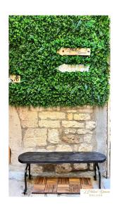 a black bench sitting in front of a wall at L'Antica Dimora Deluxe in Bari