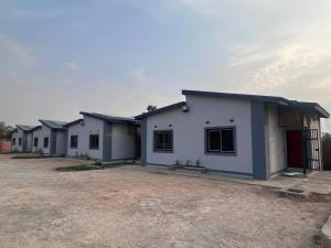 a row of houses parked in a lot at Zango Apartments in Shikalenge