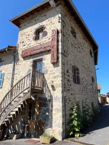 a building with a sign on the side of it at Chambre de charme in Berbezit