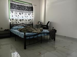 a bed in a room with a blanket on it at Everest Stay in Abu Dhabi +5 photos