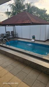 a large swimming pool with a gazebo and a swimming poolvisor at Msy Residence in Shah Alam