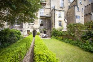 a garden in front of an old building at 2 Bed in Bath oc-bhr35 in Bath