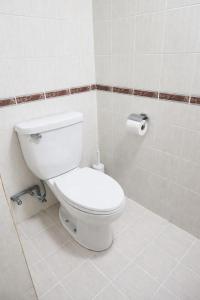 a bathroom with a toilet and a roll of toilet paper at 1BR Seaview Condo with Balcony at Riviera Bay Resort, Melaka in Malacca