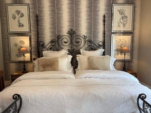 a bedroom with a large white bed with white pillows at Meifod country house hotel in Caernarfon +30 photos