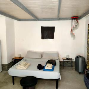 a bedroom with a bed with clothes on it at Lu Parmientu in Parabita +43 photos