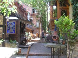 an outdoor patio with tables and chairs and a building at Chez Norbert gîte Le Riesling in Bergheim