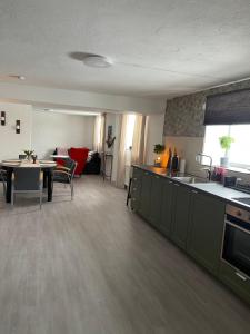 a living room with a kitchen and a dining room at Skolmästarevägen Åldersgräns 30 in Falun