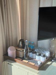 a shelf with bottles and jars on top of a dresser at Ceylan trees in Kataragama +35 photos
