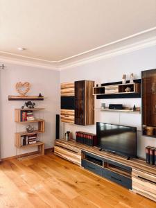 a living room with a large flat screen tv at Ferienwohnung Mariengrund in Schönau am Königssee