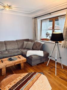 a living room with a couch and a table at Ferienwohnung Mariengrund in Schönau am Königssee