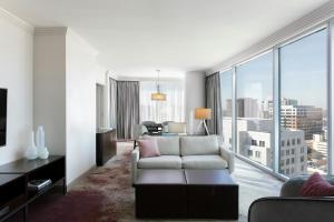 a living room with a couch and a large window at Loews Atlanta Hotel in Atlanta