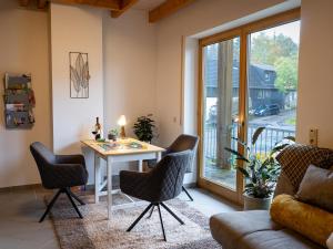 a living room with a table and chairs at Landhaus Kummerfrei in Hellenthal