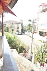 a view from a balcony of a street with buildings at GA Fernandes house in Colva +10 photos