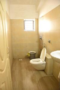 a bathroom with a toilet and a sink at GA Fernandes house in Colva