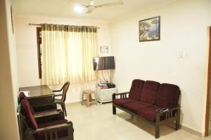 a living room with a couch and a table at GA Fernandes house in Colva