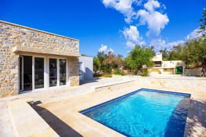 a swimming pool in the backyard of a house at Villa Omega in Lévktron