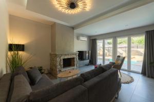 a living room with a couch and a fireplace at Villa Omega in Lévktron