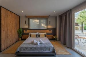 a bedroom with a bed with two towels on it at Villa Omega in Lévktron +47 photos