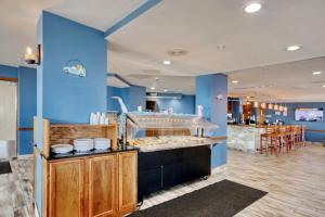 a restaurant with blue walls and a counter at The Patricia Grand in Myrtle Beach