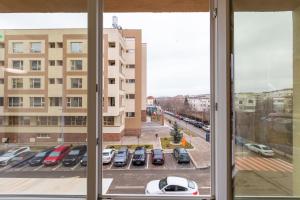 a view from a window of a parking lot at Rezidential Bacovia Orange by Rooms in Bacău