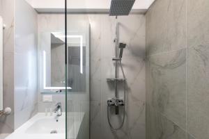 a bathroom with a shower and a sink and a tub at Rezidential Bacovia Orange by Rooms in Bacău +22 photos