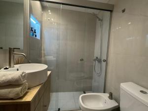 a bathroom with a shower and a sink and a toilet at En el Corazón de Rosario in Rosario +22 photos