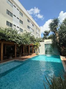 a swimming pool in front of a building at Pumma Business Hotel in Canaã dos Carajás