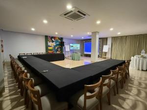 a large black table and chairs in a room at Pumma Business Hotel in Canaã dos Carajás +61 photos