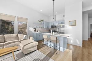 a living room and kitchen with a couch and a table at Bay View Loft in Lincoln City +27 photos