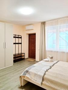 a bedroom with a large bed and a window at Dunes Trail 3 in Melnragė