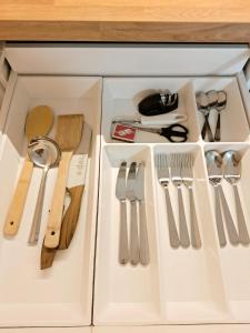 a drawer filled with utensils in a kitchen at Dunes Trail 3 in Melnragė