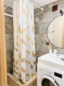 a bathroom with a washing machine and a mirror at Dunes Trail 3 in Melnragė +15 photos