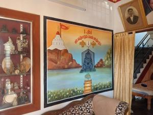 a painting on a wall in a room at Saraswati Sadan in Hospet