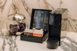 a cell phone and a box on a table at Ando Living - Abrantes 50 House in Lisbon