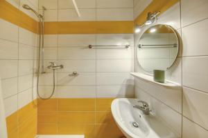 a bathroom with a shower and a sink and a mirror at Centrally located with great views and terrace in Champéry +7 photos
